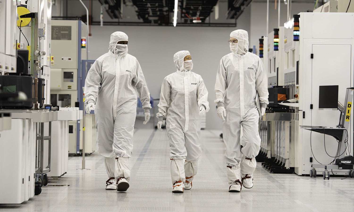 Micron team members walking in a fab