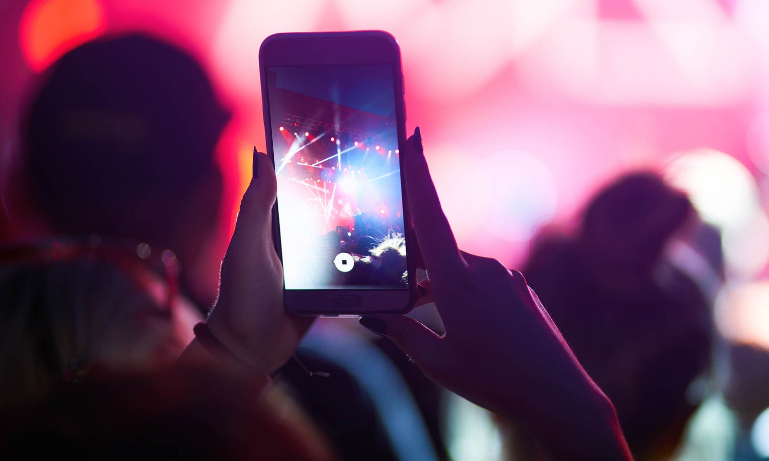 Person holding a smart phone recording a video